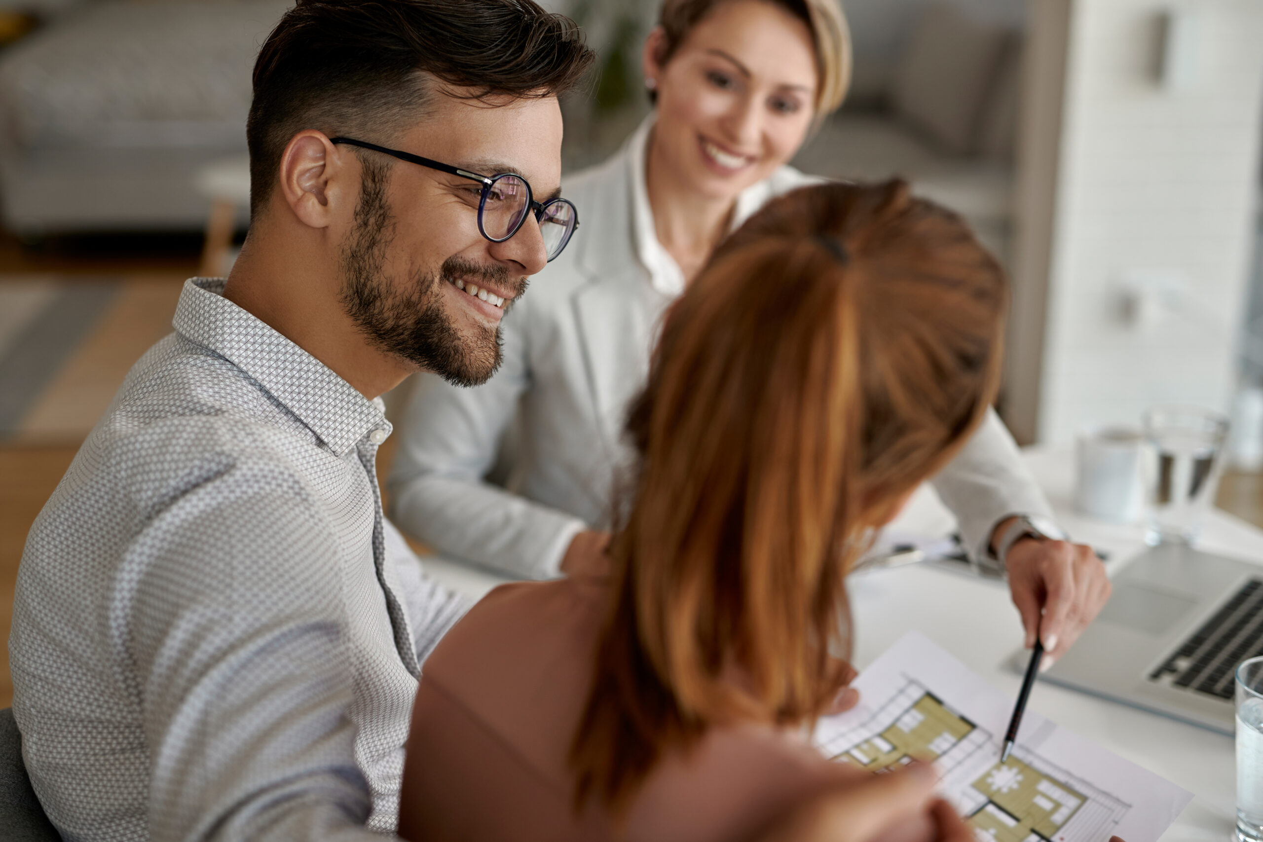 Happy man and his wife having a meeting with real estate agent i